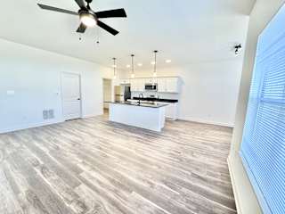 A spacious kitchen with a fan and wooden flooring.at Concord Crossing, Lafayette