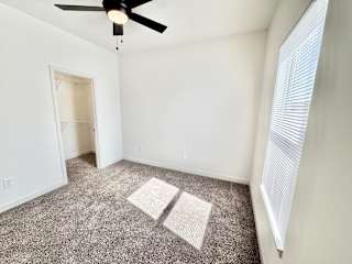 A room with a ceiling fan and carpeted floor.at Concord Crossing, Lafayette, IN 47909