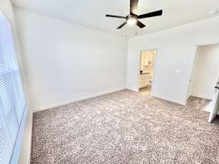 A room with a ceiling fan and carpeted floor.at Concord Crossing, Lafayette