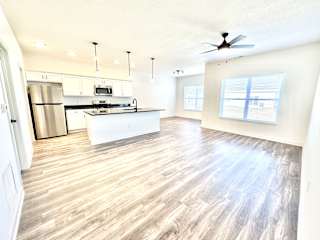 A spacious kitchen with a refrigerator, microwave, and oven.at Concord Crossing, Lafayette, 47909