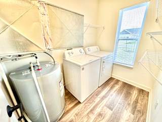 A room with a water heater and a washer and dryer.at Concord Crossing, Lafayette, 47909