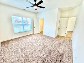 A room with a ceiling fan and carpeted floor.at Concord Crossing, Lafayette, IN 47909