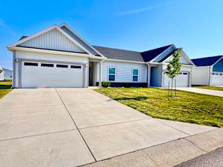 A two-story house with a garage and a driveway.