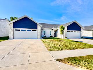 A two-story house with a garage door painted blue.