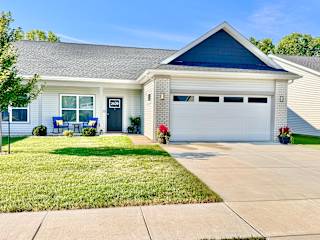 A house with a blue roof and a garage door.