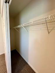 Empty white shelving unit in a room.