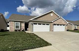 a house with a driveway and a garage door at Hawthorne Properties in Lafayette, IN 47905