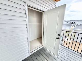 A white door is open to a balcony.
