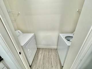 A small laundry room with a washer and dryer.