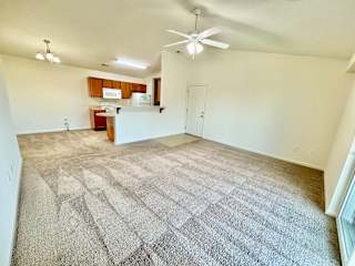 Cypress Upstairs Vaulted Living room & kitchen with fan & carpeted floors at Hawthorne Properties in Lafayette, IN 47905