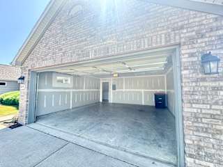 a garage door is open in a brick building at Hawthorne Properties in Lafayette, IN 47905