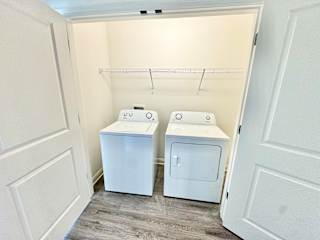 A laundry room with two washers and a shelf.
