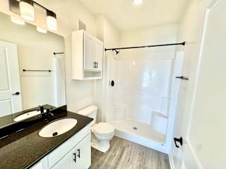 A bathroom with a sink, toilet, and bathtub.