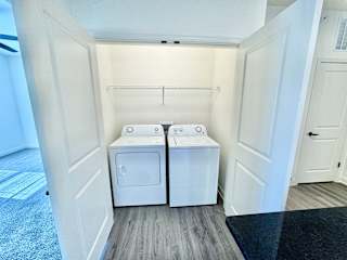 A laundry room with two washing machines and a dryer.