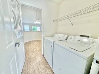 a laundry room with a washer and dryer and a door to a closet at Hawthorne Properties in Lafayette, IN 47905