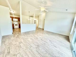 an empty living room and kitchen with a ceiling fan at Hawthorne Properties in Lafayette, IN 47905