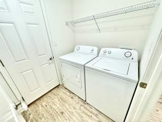 the laundry room has a washer and dryer and a door to the closet at Hawthorne Properties in Lafayette, IN 47905