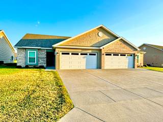 a house with a driveway and a garage door at Hawthorne Properties in Lafayette, IN 47905
