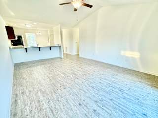 an empty living room with white walls and a ceiling fan at Hawthorne Properties in Lafayette, IN 47905
