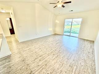 an empty living room with white walls and a ceiling fan at Hawthorne Properties in Lafayette, IN 47905