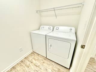 the laundry room has a washer and dryer and a shelf over the door at Hawthorne Properties in Lafayette, IN 47905