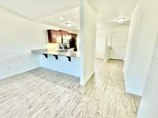 a view of a kitchen and living room in a new home at Hawthorne Properties in Lafayette, IN 47905
