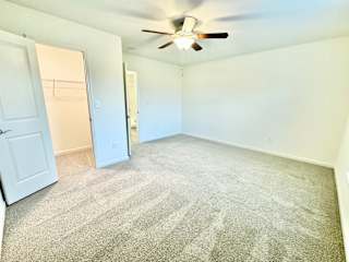 the living room of an empty home with a ceiling fan at Hawthorne Properties in Lafayette, IN 47905