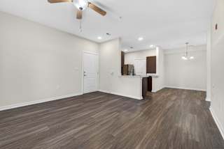 A room with a ceiling fan and lighting fixtures.