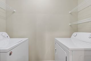 A white washing machine and dryer in a laundry room.