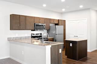 a kitchen with an island and stainless steel appliances
