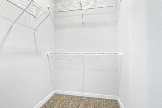a spacious walk in closet with white walls and a wire closet organizer  at Aventura at Hawk Ridge, Missouri