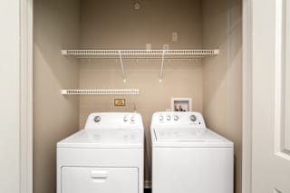 A white washing machine and dryer in a small laundry room.