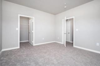 A room with two open doors and carpeted floor at Aventura at Wentzville I & II Apartments, Wentzville, Missouri