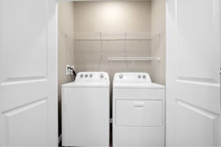 A white laundry room with two washing machines at Aventura at Wentzville I & II Apartments, Wentzville, 63385