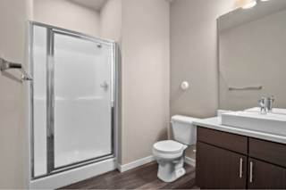 A bathroom with a toilet, sink, and shower at Aventura at Wentzville I & II Apartments, Wentzville, 63385