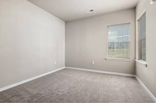 A room with a carpeted floor and a window at Aventura at Wentzville I & II Apartments, Wentzville, MO