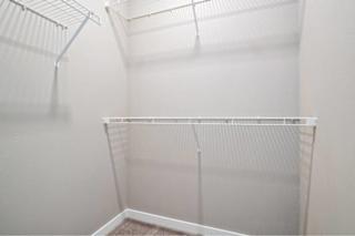 A white empty room with a carpeted floor and a wire shelf. at Aventura at Wentzville I & II Apartments, Wentzville, MO, 63385