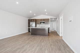 A kitchen with wooden floors and white walls.