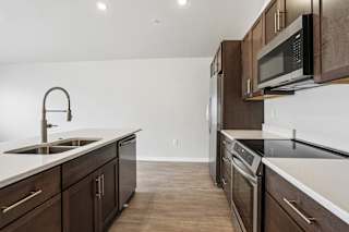 A kitchen with brown cabinets and a white countertop.