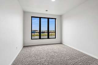 A room with a large window overlooking a landscape.