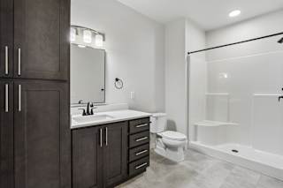 A bathroom with a sink, toilet, and shower.
