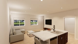 A modern kitchen with a large island and a television mounted on the wall.