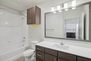Bathroom with tub shower combo and vanity 1 at Cantarra Apartments, Texas