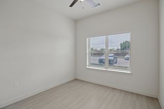 Empty bedroom with window blinds and light flooring at Cantarra Apartments, Manor, TX 78653