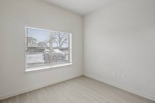 Empty bedroom with window and blinds at Cantarra Apartments, Manor, TX