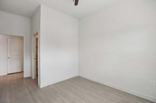 Empty bedroom with vaulted ceiling and hallway access at Cantarra Apartments, Manor