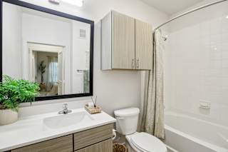 Bathroom with wood grain vanity at Matador Apartments, Austin, 78745