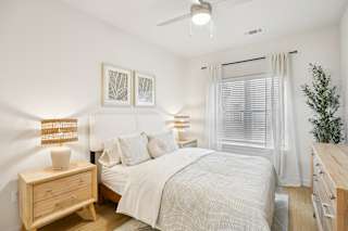 Bedroom with wood furnishings at Matador Apartments, Austin, Texas