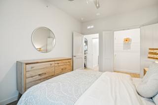 Bedroom with dresser and wall at Matador Apartments, Austin, TX 78745