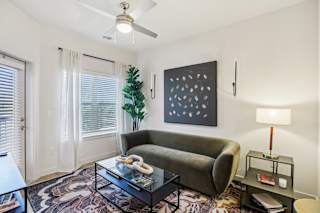 Living room with green sofa at Matador Apartments, Austin, TX